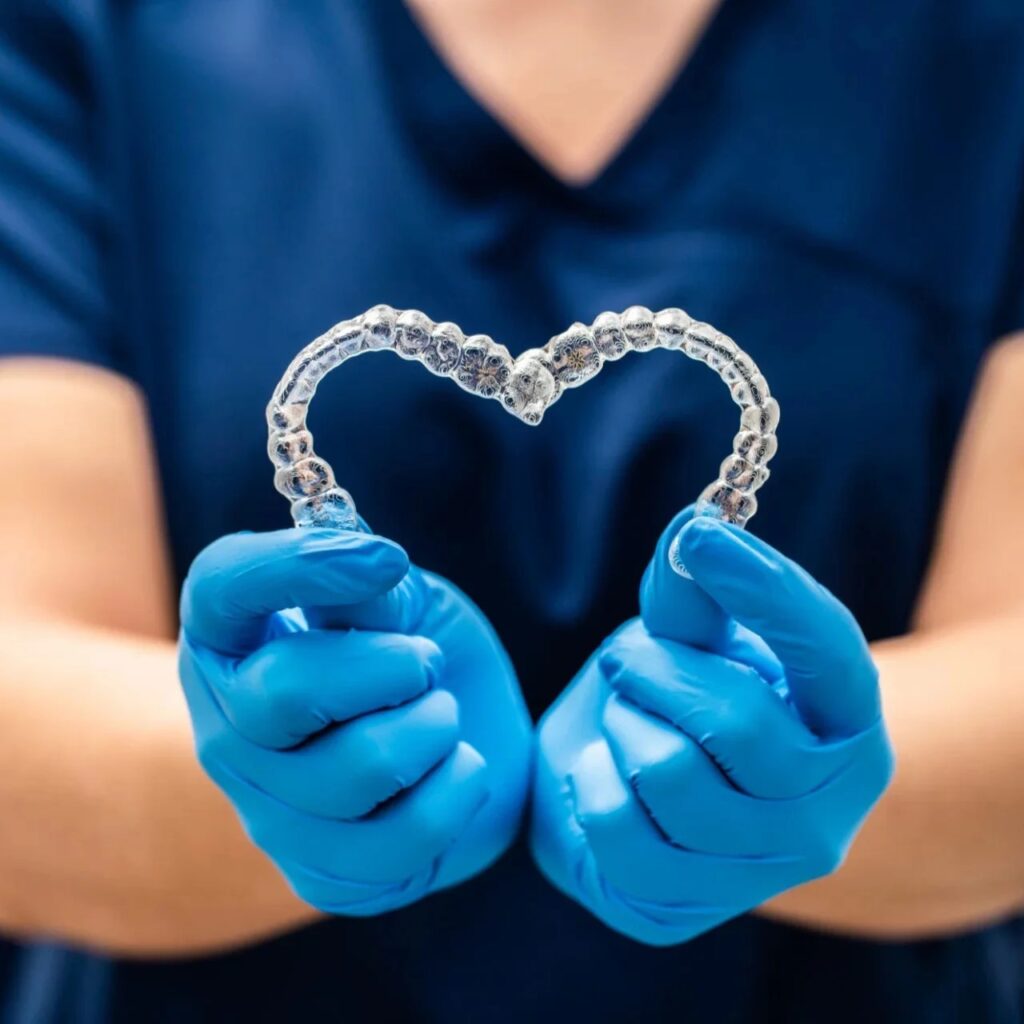 Invisalign aligners heart shaped in hands